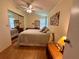 Relaxing bedroom features wood-look floors and a mirrored closet at 902 Rose Ln, Lady Lake, FL 32159