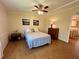 Comfortable bedroom features wood-look floors and soft, natural light at 902 Rose Ln, Lady Lake, FL 32159