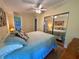 Bedroom with wood-look floors and a closet with mirrored doors at 902 Rose Ln, Lady Lake, FL 32159