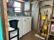 Practical laundry room with washer, dryer, and storage shelving for organization at 902 Rose Ln, Lady Lake, FL 32159