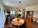 Inviting dining and living area with wood floors, creating a warm and welcoming atmosphere at 902 Rose Ln, Lady Lake, FL 32159