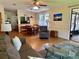 Open concept living and dining area featuring wood flooring and natural light at 902 Rose Ln, Lady Lake, FL 32159