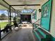 Relaxing porch with ceiling fan, ample seating, and steps with painted risers at 902 Rose Ln, Lady Lake, FL 32159