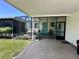 Inviting screened porch with neutral decor, complemented by a cooling ceiling fan at 902 Rose Ln, Lady Lake, FL 32159