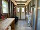 Unfinished shed interior featuring double doors, a workbench, and open framing at 902 Rose Ln, Lady Lake, FL 32159