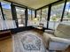 Cozy sunroom featuring ample light and neutral decor, perfect for relaxation at 902 Rose Ln, Lady Lake, FL 32159