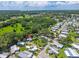 Aerial view of the property within a community surrounded by lush greenery and other homes at 10 Cocos Plumosa Dr, Eustis, FL 32726