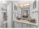 Bathroom featuring a toilet, vanity, mirror and shower/tub with towels hung on the wall at 10 Cocos Plumosa Dr, Eustis, FL 32726