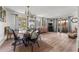 Open dining area with wood-look floors and sliding glass doors leading to the lanai at 10 Cocos Plumosa Dr, Eustis, FL 32726