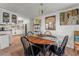 Cozy dining area with a round table, classic chairs, and bright natural light at 10 Cocos Plumosa Dr, Eustis, FL 32726