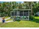Charming single-story home with a screened-in porch, well-maintained landscaping, and a cozy, inviting appeal at 10 Cocos Plumosa Dr, Eustis, FL 32726