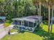 Charming single-story home with a screened-in porch, well-maintained landscaping, and a cozy, inviting appeal at 10 Cocos Plumosa Dr, Eustis, FL 32726