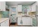 Bright kitchen with white cabinets, modern faucet, and a welcoming door leading to the exterior at 10 Cocos Plumosa Dr, Eustis, FL 32726