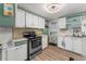 Classic kitchen features clean white cabinets, stainless-steel oven, and bright lighting at 10 Cocos Plumosa Dr, Eustis, FL 32726