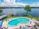 A lovely community pool with lake view and patio seating offers a tranquil experience at 10 Cocos Plumosa Dr, Eustis, FL 32726