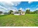 Lush backyard showcasing an enclosed sunroom extension, adding a charming touch to the home at 10331 Sw 45Th Ave, Ocala, FL 34476
