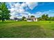 Expansive backyard showcasing lush green lawn and a charming sunroom extension of the house at 10331 Sw 45Th Ave, Ocala, FL 34476