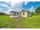Well-kept backyard with green grass, a sunroom, and a mulched area, offering peaceful outdoor living at 10331 Sw 45Th Ave, Ocala, FL 34476