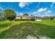 Scenic backyard showcasing a well-maintained lawn and an enclosed sunroom addition to the home at 10331 Sw 45Th Ave, Ocala, FL 34476