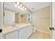 Bathroom featuring double sinks, neutral color palette, and a large mirror at 10331 Sw 45Th Ave, Ocala, FL 34476