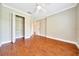 Bedroom featuring wood floors, overhead light, and closet at 10331 Sw 45Th Ave, Ocala, FL 34476