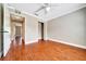 Bedroom with hardwood floors, ceiling fan, closet, and neutral paint at 10331 Sw 45Th Ave, Ocala, FL 34476