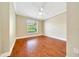 Bright bedroom with beautiful hardwood floors, a ceiling fan, and a window at 10331 Sw 45Th Ave, Ocala, FL 34476