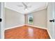 Bright bedroom with beautiful hardwood floors, a ceiling fan, and a window at 10331 Sw 45Th Ave, Ocala, FL 34476