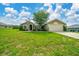 Charming single-story home with a well-manicured lawn and mature tree in the front yard at 10331 Sw 45Th Ave, Ocala, FL 34476