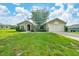 Charming single-story home with a well-manicured lawn and mature tree in the front yard at 10331 Sw 45Th Ave, Ocala, FL 34476