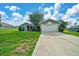 Charming single-story home with a well-manicured lawn and mature tree in the front yard at 10331 Sw 45Th Ave, Ocala, FL 34476