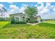 Charming single-story home with a well-manicured lawn and mature bushes in the front yard at 10331 Sw 45Th Ave, Ocala, FL 34476