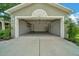 Attached two-car garage featuring ample storage space, built-in shelving, and a water heater at 10331 Sw 45Th Ave, Ocala, FL 34476