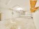 Spacious two-car garage with overhead lighting and built-in shelves for ample storage solutions at 10331 Sw 45Th Ave, Ocala, FL 34476