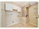 Laundry room with tile flooring and built in white storage space at 10331 Sw 45Th Ave, Ocala, FL 34476