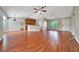 Open concept living room with ceiling fan, hardwood floors, and natural light at 10331 Sw 45Th Ave, Ocala, FL 34476
