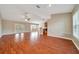 Spacious living room featuring hardwood floors, ceiling fan, and access to kitchen at 10331 Sw 45Th Ave, Ocala, FL 34476