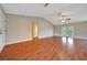 Bright living room with hardwood floors, ceiling fan, and glass doors to the backyard at 10331 Sw 45Th Ave, Ocala, FL 34476