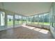 Bright sunroom with tile floors and multiple windows offering backyard views at 10331 Sw 45Th Ave, Ocala, FL 34476