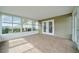 Sunroom with tile floors and sliding glass doors with views of the backyard at 10331 Sw 45Th Ave, Ocala, FL 34476