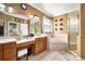 Well-lit bathroom features a dual sink vanity, soaking tub, tiled shower, and elegant neutral decor at 1043 Juliette Blvd, Mount Dora, FL 32757