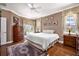 Cozy bedroom with neutral walls, hardwood floors, and natural light at 1043 Juliette Blvd, Mount Dora, FL 32757