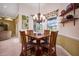 Charming breakfast nook with a chandelier and windows that provide backyard views at 1043 Juliette Blvd, Mount Dora, FL 32757