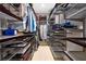 Organized walk-in closet with custom shelving and rods, providing ample storage space for clothing and accessories at 1043 Juliette Blvd, Mount Dora, FL 32757