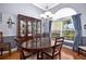 Elegant dining room with a large wooden table, china cabinet, and window at 1043 Juliette Blvd, Mount Dora, FL 32757