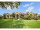 Charming traditional home with a manicured lawn, lush landscaping, and an inviting facade at 1043 Juliette Blvd, Mount Dora, FL 32757