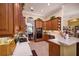 Efficient kitchen features wooden cabinetry, tile backsplash, and modern appliances at 1043 Juliette Blvd, Mount Dora, FL 32757