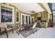 Outdoor kitchen with built-in grill, stainless steel hood, dining table, and seating area at 1043 Juliette Blvd, Mount Dora, FL 32757