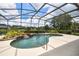 Inviting in-ground pool featuring a waterfall and screened-in lanai for ultimate relaxation at 1043 Juliette Blvd, Mount Dora, FL 32757