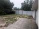 Large backyard featuring a stone patio, modern metal fence, and ample space for outdoor activities at 11532 Beaman Cir, Clermont, FL 34711